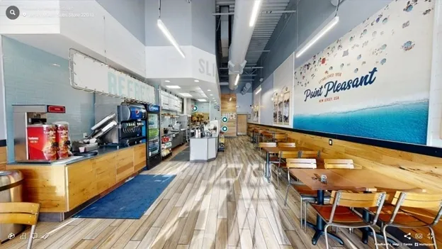 A restaurant with wooden floors and tables.