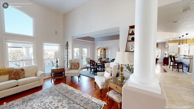 A living room with hard wood floors and white walls.