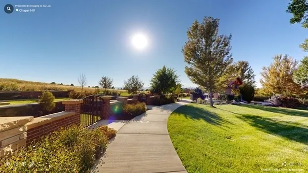 A walkway with trees and bushes in the background.