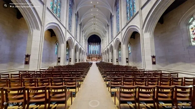 A large cathedral with many rows of chairs.