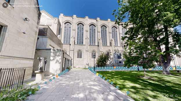 A large building with many windows and a long walkway.